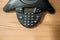 top view of speakerphone on wooden table