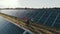 Top view of specialists walking across a solar power plant. Business team of industrial engineers walking on solar farm