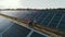 Top view of specialists walking across a solar power plant. Business team of industrial engineers walking on solar farm
