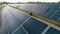 Top view of specialists walking across a solar power plant. Business team of industrial engineers walking on solar farm