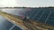 Top view of specialists walking across a solar power plant. Three employees of alternative power plant walking and