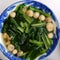Top view spinach and straw mushroom soup bowl for vegan meal
