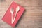 Top view spoon, fork and book on wooden plank background