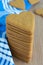 Top view of stacked heart shaped gingerbread cookies, on wooden background and blue napkin