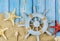 Top view star fish the sailor& x27;s captain& x27;s wheel on blue wooden boards