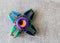 Top view on star shaped stainless steel metalic fidget spinner on marble background