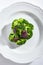 Top view of Steamed Broccoli on White Restaurant Plate Isolated