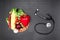 Top view of stethoscope,various organic vegetables and fruits on grey
