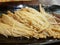 Top view of Stir fried Golden Mushroom or Enokitake on black plate.