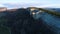 Top view of stone cliff with green bush at peak. Shot. Beautiful mountain landscape with rock casting shadow from