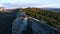 Top view of stone cliff with green bush at peak. Shot. Beautiful mountain landscape with rock casting shadow from