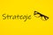 Top view of Strategie written on yellow background with glasses