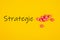 Top view of Strategie written on yellow background with red