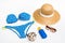 Top view of straw hat, sunglasses, swimsuit and sunscreen