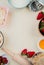 top view of strawberries in bowl and melted butter with flour and oats with rolling pin on white background with copy space