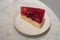 Top view Strawberries cake on white ceramic plate on Marble table background