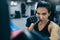 Top view of strong brunette attractive female trainer punching a bag with kickboxing gloves in the gym workout. Sport, fitness,