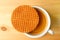 Top View of a Stroopwafel Placed on Top of Hot Coffee Cup Served on Wooden Table