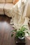 Top view of stylish brightly part of living room with old vintage suitcase and potted plant on luxury wooden floor