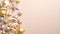 Top view stylish Christmas decorations on ivory background. Flat lay golden, silver and pink Xmas balls and stars with ribbon and