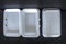 Top view of Styrofoam takeaway boxes, white foam boxes, rectangular shaped clamshell style container with an attached lid, on