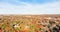 Top view suburbs Dallas houses near park forest with colorful autumn color