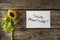 Top view of sunflower lying next to a motivational message Think