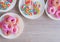 Top view, sweet food on wooden table. Glazed mini donuts and candy sugar