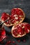 Top view of a sweet, fresh and natural garnet for beverages on a stone background. Bright red pomegranate broke down