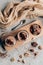 top view of sweet homemade desserts in glass jars and chocolate pieces on wooden