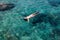 Top view of swimming woman in the transparent turquoise sea