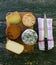 Top view of a table of assorted cheeses blue cheese, smoked cheese ... on a rustic table with a knife