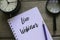 Top view of table clock,magnifying glass,pencil and notebook written with Live Webinar on wooden background