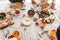 Top view of table full of delicious food. Close up fresh bread with cheese and bowls with pumpkin soups on lunch in cafe