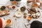 Top view of table full of delicious food. Close up fresh bread with cheese on wood board and bowls with pumpkin soups on