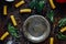 Top view of table with italian tortiglioni pasta, metal plate and spices.