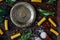 Top view of table with italian tortiglioni pasta, metal plate and spices.