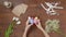 Top view of a table with items to create a composition for Easter. Women's hands knock eggs against each other and