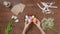 Top view of a table with items to create a composition for Easter. Women's hands knock eggs against each other and