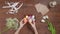 Top view of a table with items to create a composition for Easter. Women's hands knock eggs against each other and