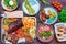 Top view table with many nutricious dishes. Meat, vegetables, salads and bread