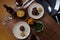 Top view of a table with plates of delicious stake, greens, and fries