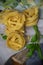 Top view of tagliatelle with basil and cheese on white dishcloth