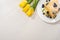 Top view of tasty crepes with blueberries and mint on plate near yellow tulips