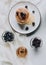 top view of tasty homemade pancakes with honey blueberries and blackberries