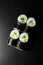 Top view on tasty kappa maki sushi rolls with cucumbers and rice wrapped in nori on dark background