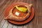 Top view on tasty traditional Adjarian Khachapuri - open baked pie with meat and pepperyolk on wooden tray. Traditional