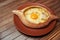 Top view on tasty traditional Adjarian Khachapuri - open baked pie with melted salt cheese suluguni and egg yolk on