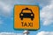 Top view of Taxi sign on lightblue cloudy sky background
