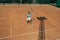 Top view of tennis sportswoman playing tennis on outside court